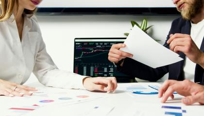 Two people at a desk with papers