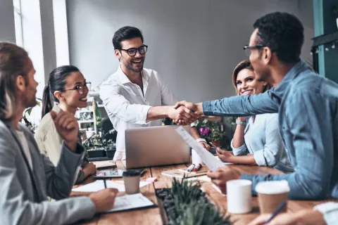 Office workers shaking hands.