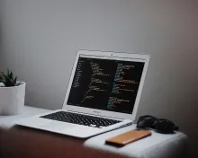 A laptop displaying programming